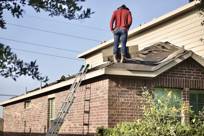 Professional roofer working on a residential roof in Moondance